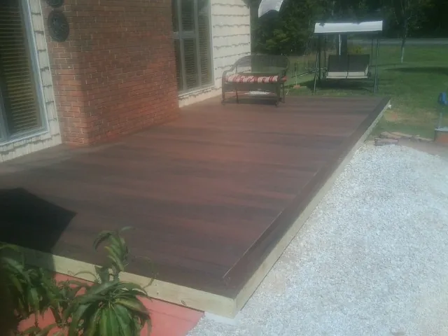 Freshly stained wood deck built against a brick home in Stoystown