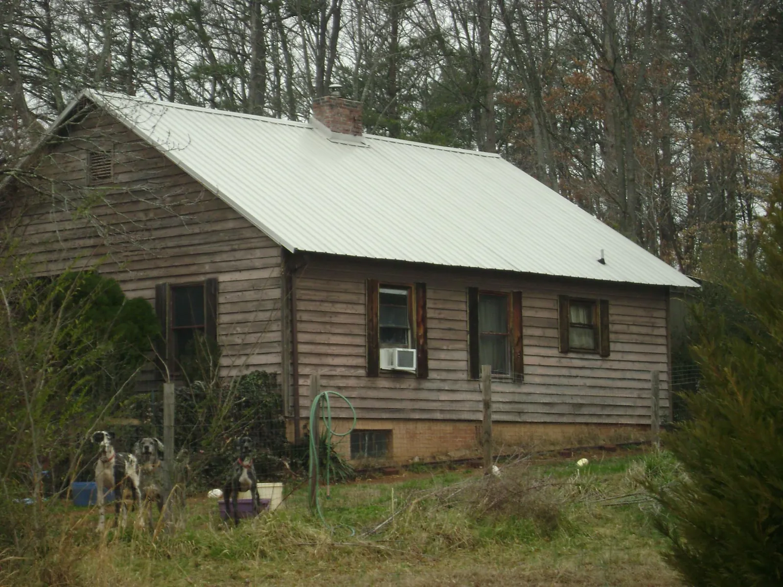 White metal roof on an old wood sided farmhouse, from a Metal Roof Installation job in Stoystown